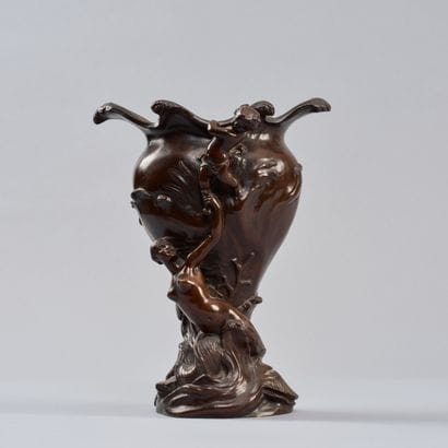 A bronze vase with a medallic patina, flared...