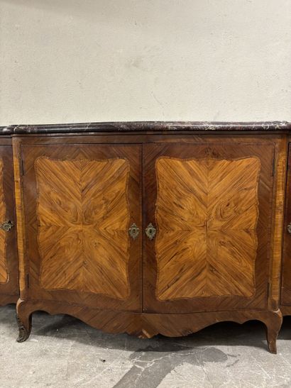 A large enfilade in veneered wood and frieze...