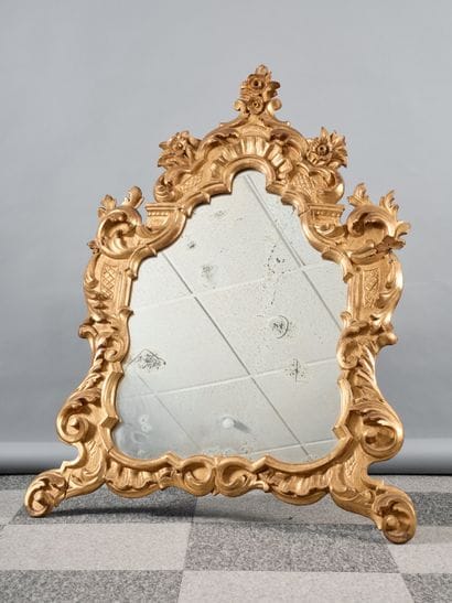 Large carved and gilded wood mirror decorated...