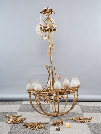 A large bronze chandelier with a gilded patina,...