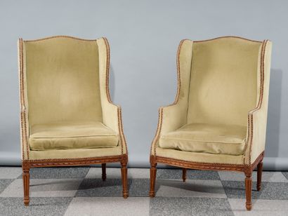 Pair of ear-flap bergères in carved natural...