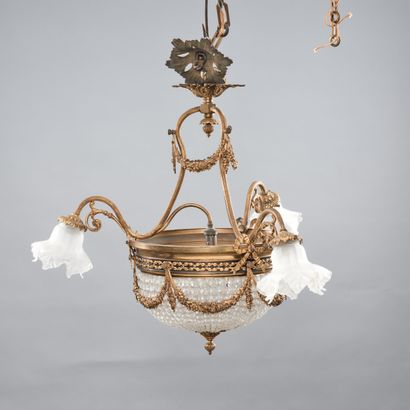 A three-light bronze chandelier with a gilded...