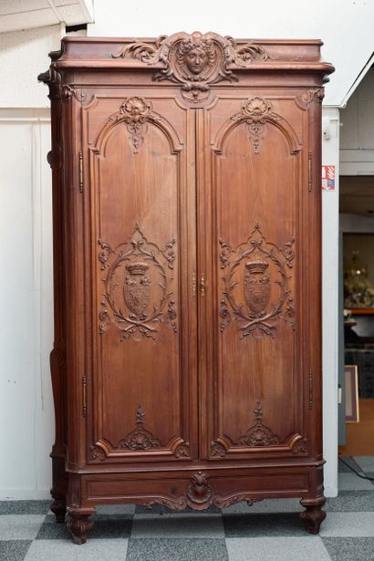 Carved wood armoire opening with two large...