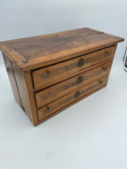 A walnut and rosewood veneered doll's chest...