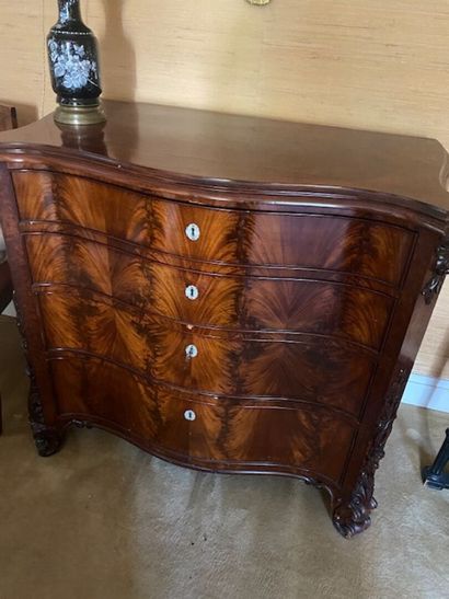 A mahogany and mahogany veneered curved chest...