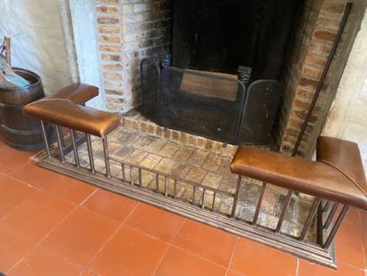 A fireplace bench in brushed metal and brown...