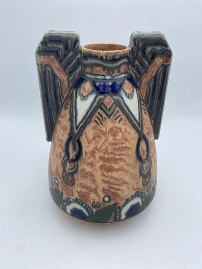 Un vase en faïence polychrome à décor végétal...