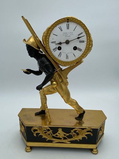 An ormolu and blackened clock decorated with...
