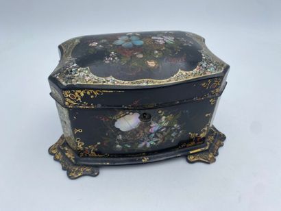 A lacquered wood tea chest with floral and...