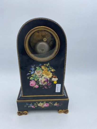 PARIS
A black porcelain clock decorated with...