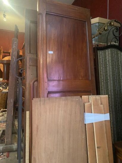 An armoire in molded natural wood carved...
