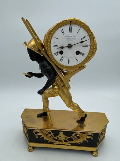 An ormolu and blackened clock decorated with...