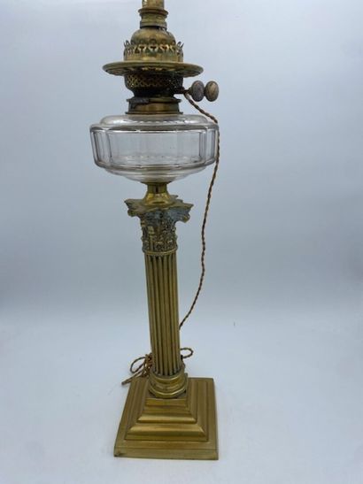 A bronze Corinthian column oil lamp topped...