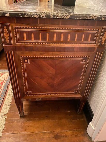 A chest of drawers in wood veneer and marquetry...