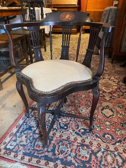 A confessional armchair in blackened wood...