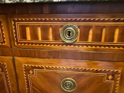A chest of drawers in wood veneer and marquetry...