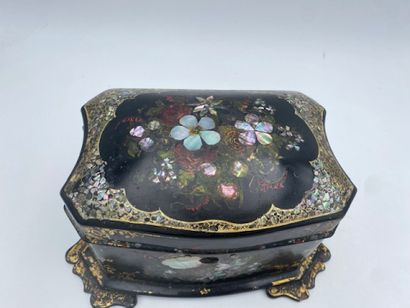 A lacquered wood tea chest with floral and...