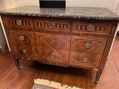 A chest of drawers in wood veneer and marquetry...