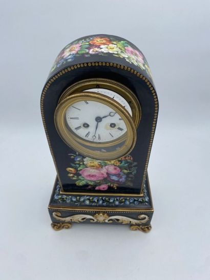 PARIS
A black porcelain clock decorated with...