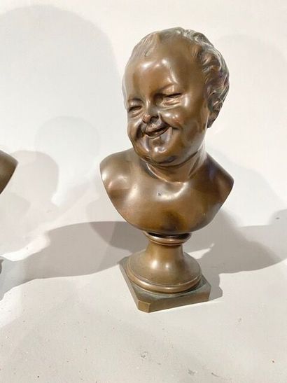 Pair of busts of grimacing children in bronze...