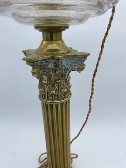 A bronze Corinthian column oil lamp topped...