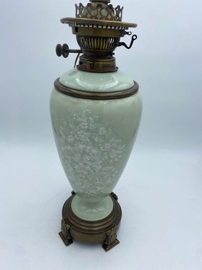 An ovoid earthenware oil lamp with a celadon...