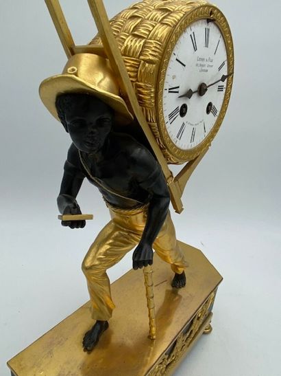 An ormolu and blackened clock decorated with...