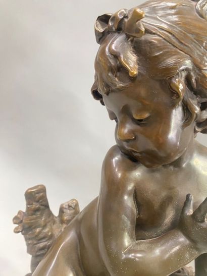 After Auguste MOREAU - A seated putto with...
