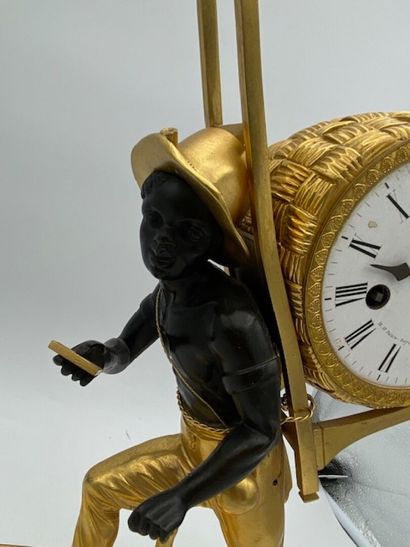 An ormolu and blackened clock decorated with...