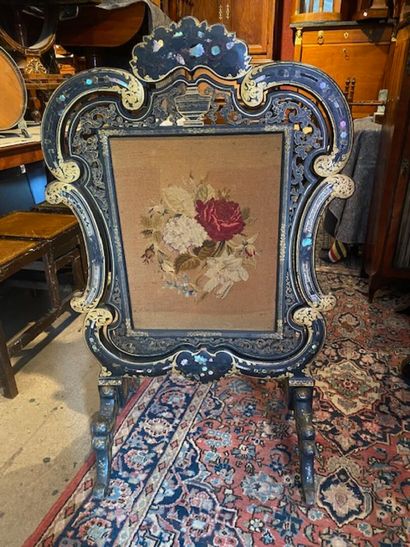 A blackened and gilded wood screen with vegetal...