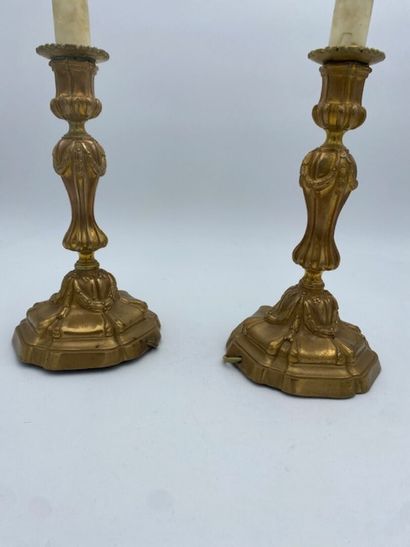 A pair of chased bronze torches 
decorated...
