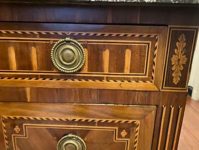 A chest of drawers in wood veneer and marquetry...