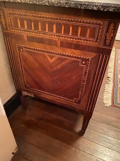 A chest of drawers in wood veneer and marquetry...