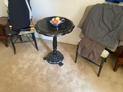 A pedestal table in black lacquered wood...