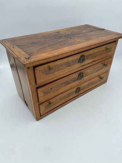 A walnut and rosewood veneered doll's chest...