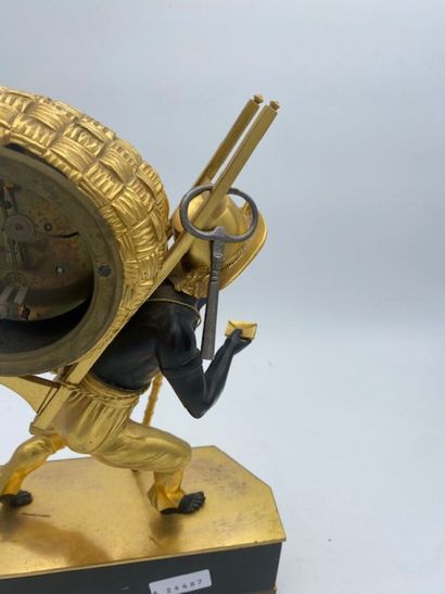 An ormolu and blackened clock decorated with...