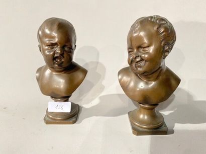 Pair of busts of grimacing children in bronze...