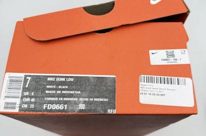 NIKE 
Pair of gray and white DUNK low-top...