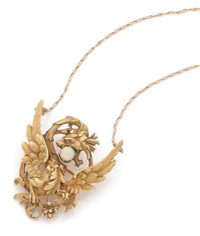 Gold pendant brooch made of a phoenix holding...