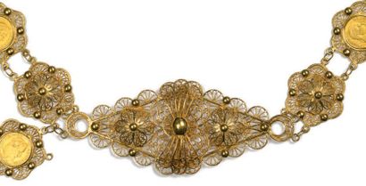 A filigree gold belt formed by floral rosettes...