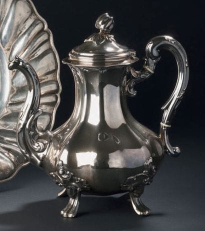 DERAIN
Silver teapot with swollen ribs resting...