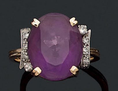 Ring decorated with an oval amethyst between...