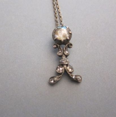 Gold and silver pendant adorned with a central...