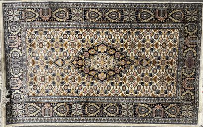 
Iranian wool carpet with a beige background...