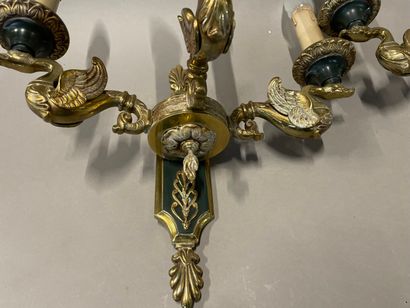 A pair of ormolu sconces with three lights...