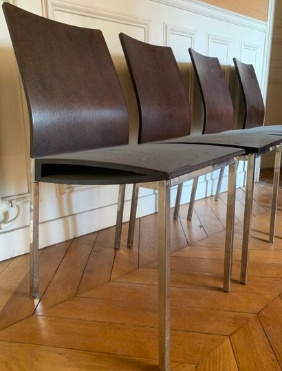 Four stained wood chairs with metal legs.

Contemporary...