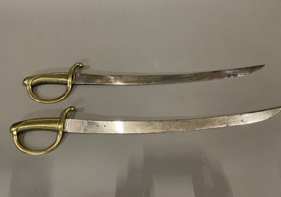Two swords with fluted brass handles, flat...