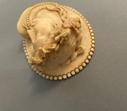 Oval medallion in ivory carved in high relief...