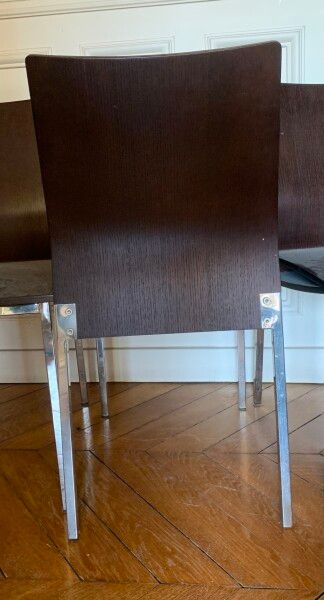 Four stained wood chairs with metal legs.

Contemporary...