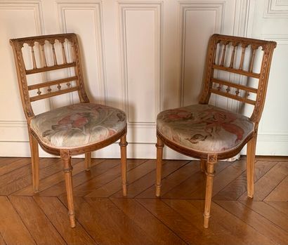 Two carved and molded wood chairs decorated...